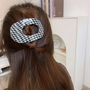 Large houndstooth pattern hair claw clip for elegant hairstyles shown on back of head