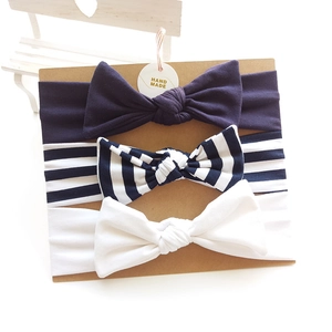 Three-pack soft cotton baby headbands with large bows in navy blue, stripes, and white