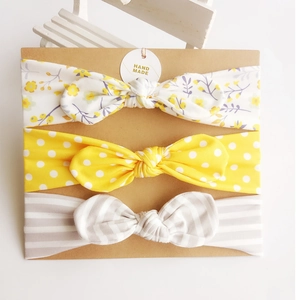 Set of 3 baby cotton bow headbands with floral, polka dot, and striped patterns on card