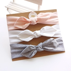 3-pack soft cotton baby bow headbands in pink white and grey on display card