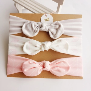 Three-pack cotton baby bow headbands with stripes and patterns on craft card