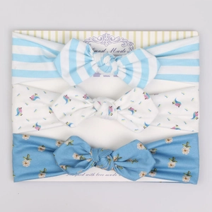Detailed set of three baby headbands with blue stripes, bird prints, and floral bows