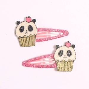 Macro detail of glitter BB hair clips with 3D panda cupcake resin charms for kids