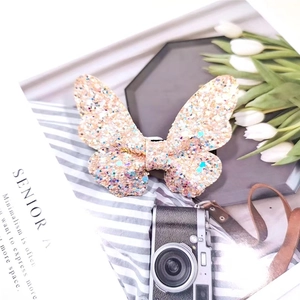 Sparkly glitter butterfly hair clip for kids with colorful sequins in a stylish setting
