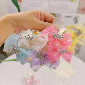 Detail view of multi-colored kids mesh bow hair ties with sparkling crown and star glitters