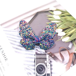 Rainbow glitter sequin butterfly hair clip for girls on a stylish display tray