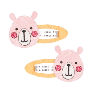 Dettaglio di fermagli per capelli a forma di orso rosa glitterato con rivestimento giallo