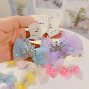Detail of tulle bow hair clips with glitter star sequins and crystal crown decor