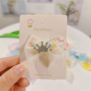 White tulle bow hair clip for girls featuring a sparkling rhinestone crown detail