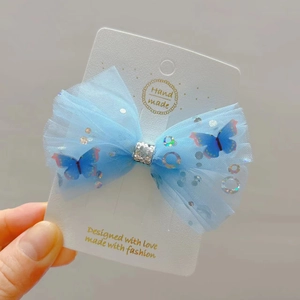 Light blue tulle bow hair clip with colorful 3D butterflies and shiny sequins on a card