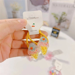 Cute ice cream hair ties for girls with sparkly rainbow sequins and yellow elastic bands