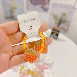 Detail shot of cute orange strawberry charms on braided elastic hair ties for girls