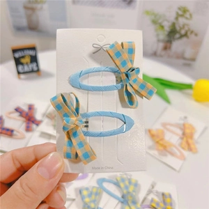 Pair of light blue plaid fabric bow BB hair clips displayed on a white product card