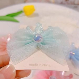 Close-up of a light blue mesh bow hair clip with a pearlescent crown and pearl center