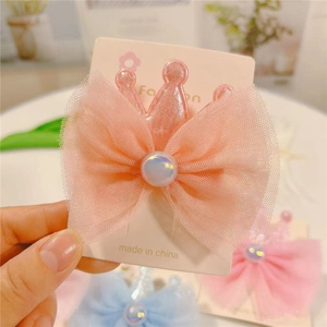 Pink princess hair clip featuring a mesh crown bow with a pearly center on display card