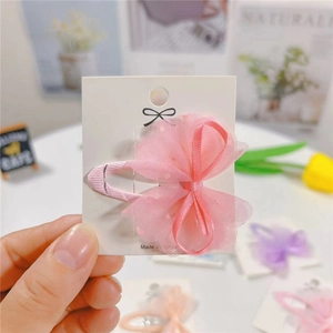 Pink polka dot tulle mesh bow hair clip for girls with a soft fabric-wrapped duckbill base