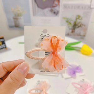 Orange polka dot mesh bow hair clip for girls with a Korean style design on display card