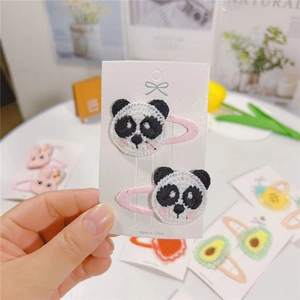 Cute embroidered panda hair clips for babies featuring pink fabric-wrapped safety pins