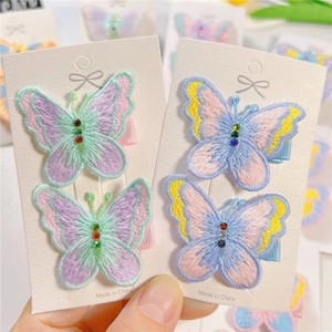 Detailed view of embroidered butterfly hair clips with colorful rhinestones for girls