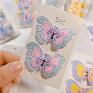 Detailed embroidery butterfly hair clip with colorful rhinestones on white card display