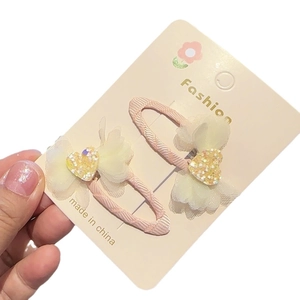 Pink ribbon hair clips with white chiffon flowers and shiny yellow heart sequins