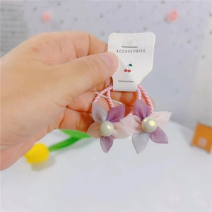 Detail von rosa und lila Organza-Blumen-Haargummis mit Perlen für Mädchen und Kinder