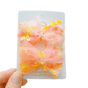 Paio di fermagli per capelli a farfalla con paillettes arancioni e rosa per bambine
