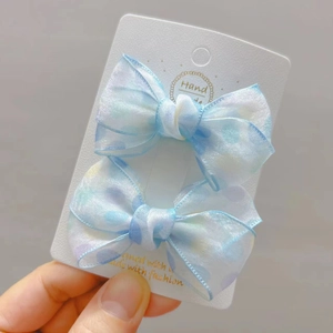 Detail of blue polka dot organza bow hair clips on handmade display card