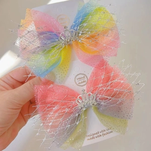 Detail of glitter rainbow mesh hair bows with diamond crowns for girls
