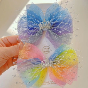 Detailed view of handmade princess mesh bow clips with crystal crown and gradient colors
