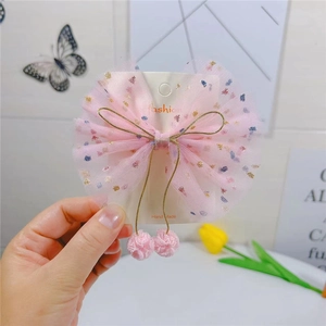 Nœud papillon en tulle rose pour filles avec paillettes colorées et pendentifs pompons