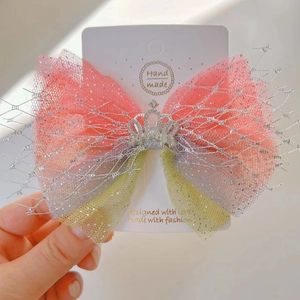 Detail showing gradient mesh bow hairclip with glitter powder and rhinestone crown decoration