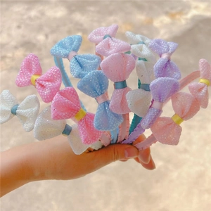 Detail of glittery sequin bow headbands in various pastel colors for girls and children