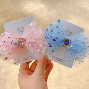 Detail of star tulle bow hair clips with faux blue and pink sapphires for girls