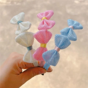 Detail showing three sequin mesh bow headbands with ribbed ribbon wrapping for kids