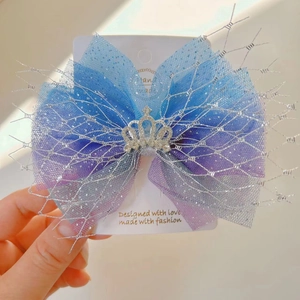 Close-up of a gradient mesh hair bow with a silver crown rhinestone for girls
