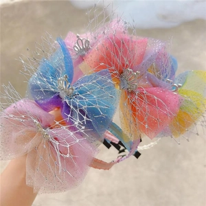 Close-up of kids' rainbow mesh headbands featuring sparkling silver crowns and glitter