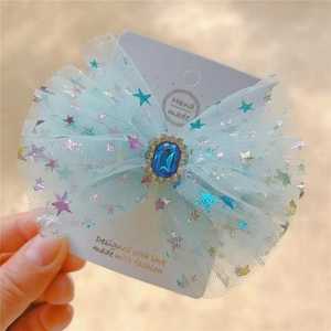 Blue mesh ribbon hair clip with sparkling star sequins and centered sapphire gemstone