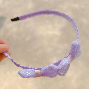 Detail of lavender sequin bow headband for girls with shimmering fabric and soft ends