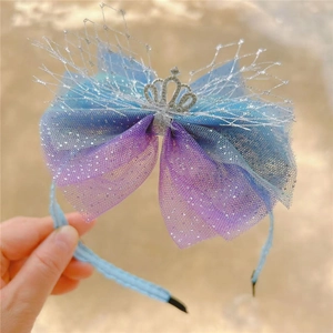 Detailed close-up of a blue and purple gradient mesh bow headband with a crystal crown
