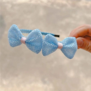 Blue children's headband with glittery mesh bows and pink ribbon detail for girls