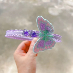 Detail of embroidered butterfly and purple heart rhinestones on the sweet style headband