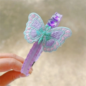 Close-up of embroidered butterfly headband with purple heart crystals and satin fabric wrap