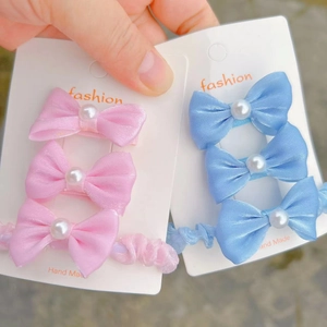 Elegant 3-piece kids hair accessory set with satin bow and pearl detail on cards