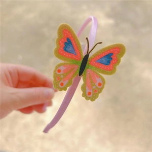 Pink girls headband featuring a large sparkling sequin butterfly hair accessory