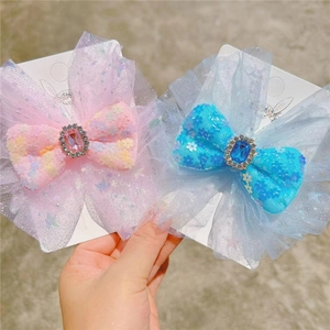 Detailed macro of mesh bow hair clips with sequins and central square gemstone