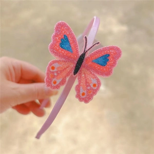 Pink glitter butterfly headband for girls with shimmering colorful decorative accents