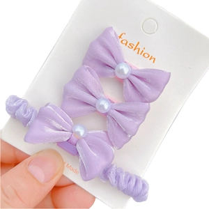 Elegant 3-piece purple bow hair clips set with pearls and satin fabric on card