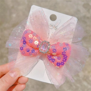 Princess hair bow with pink tulle layers, sequins, and a crystal gemstone center clip