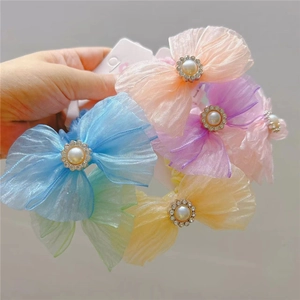 Close-up of mesh bow hair ties with faux pearls and rhinestones in six Macaron colors